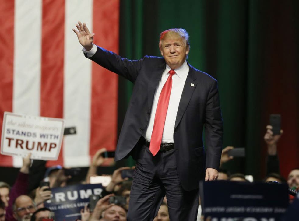 Donald Trump acknowledges the crowd before addressing supporters at a campaign rally, Monday, 21 December 2015