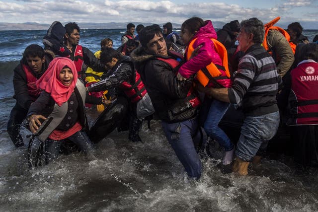 Afghans arrive on the island of Lesbos after crossing the Aegean Sea from Turkey in bad weather. More than 800,000 refugees are said to have entered Greece by sea this year