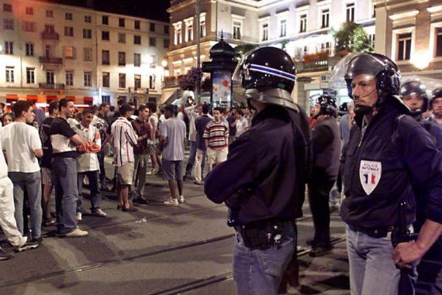French police stand between local youths and England fans during the 1998 World Cup