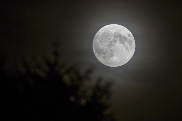 The full moon rises over Lausanne, France, in September 2015