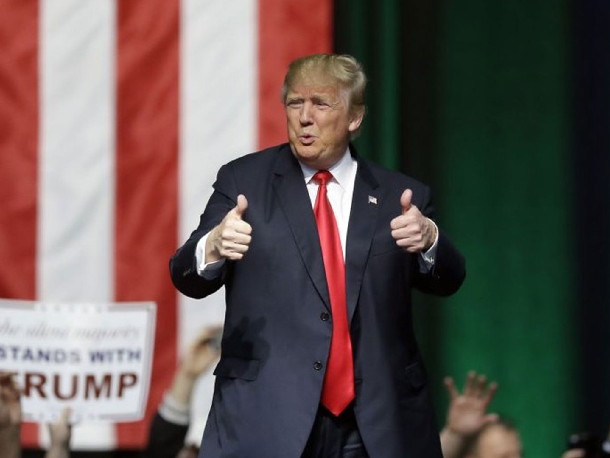 Republican presidential candidate Donald Trump acknowledges the crowd at a campaign rally in Grand Rapids, Michigan, on December 21