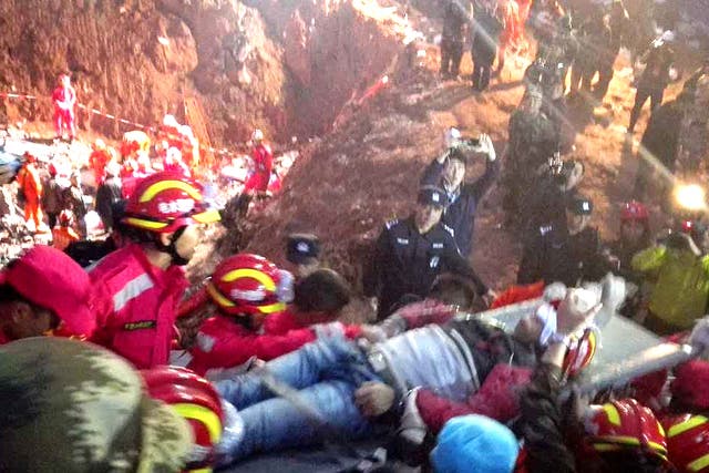 Rescuers carry 19-year-old survivor Tian Zeming after he was pulled from debris