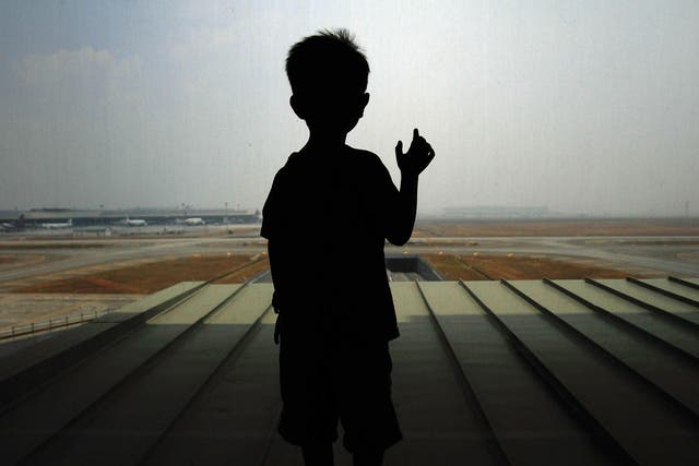 A boy waits for his family members arrival at Kuala Lumpur International Airport