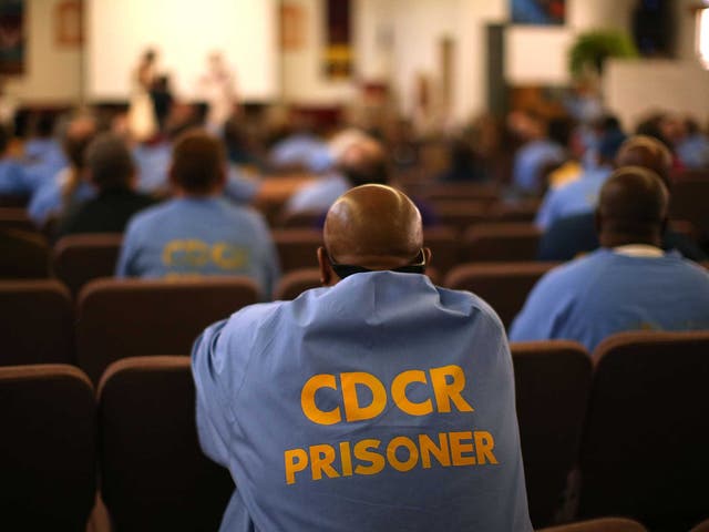 A prisoner listens to a theatre performance inside in May of this year