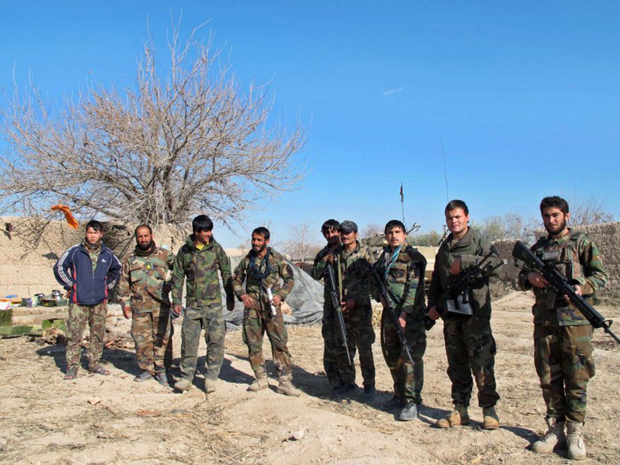 Members of the Afghan security forces pose for a picture during an operation against Taliban fighters in Helmand province, Afghanistan, 22 December 2015