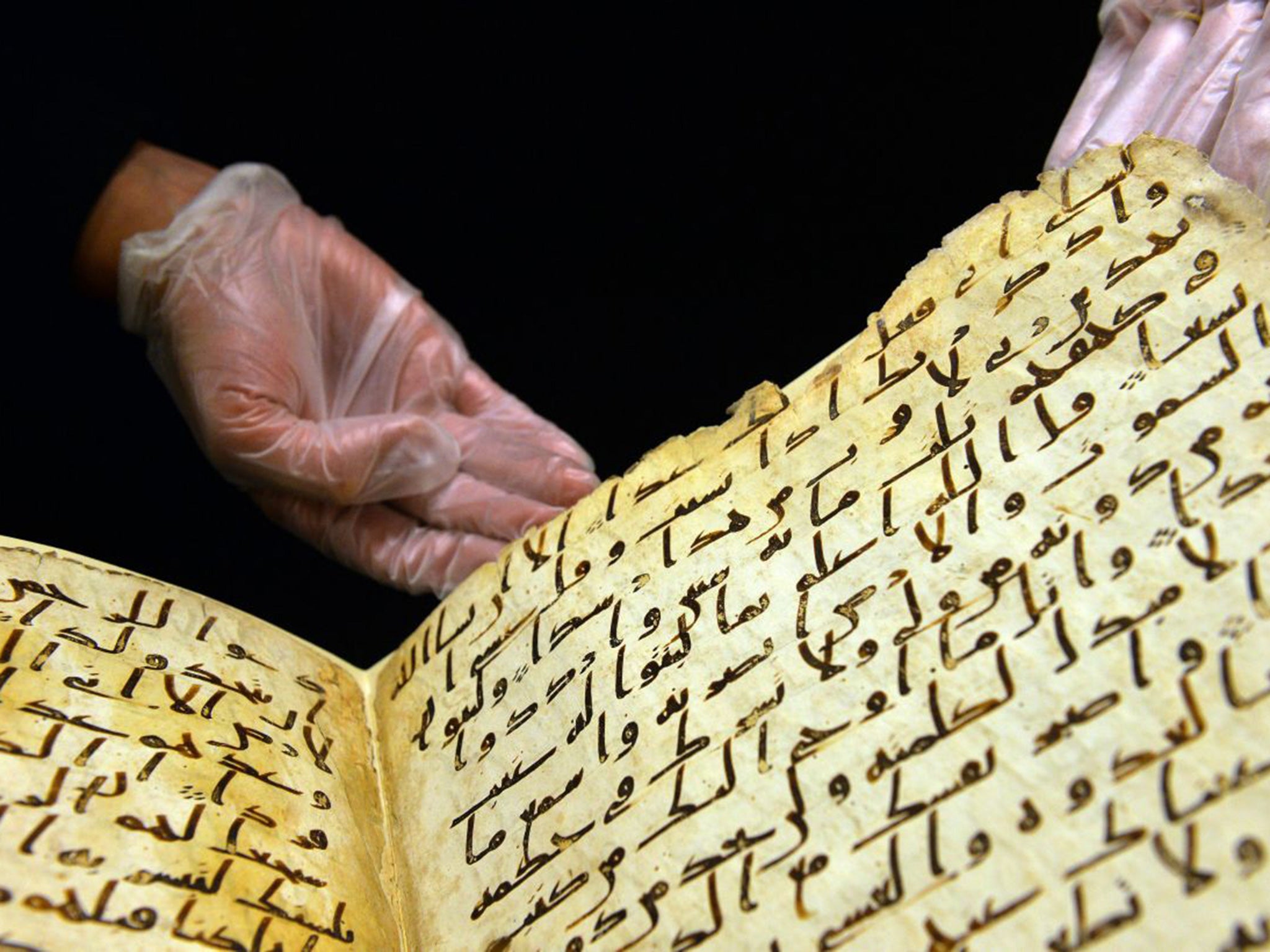 Marie Sviergula, conservator of the University of Birmingham holds the Koran manuscript in Birmingham