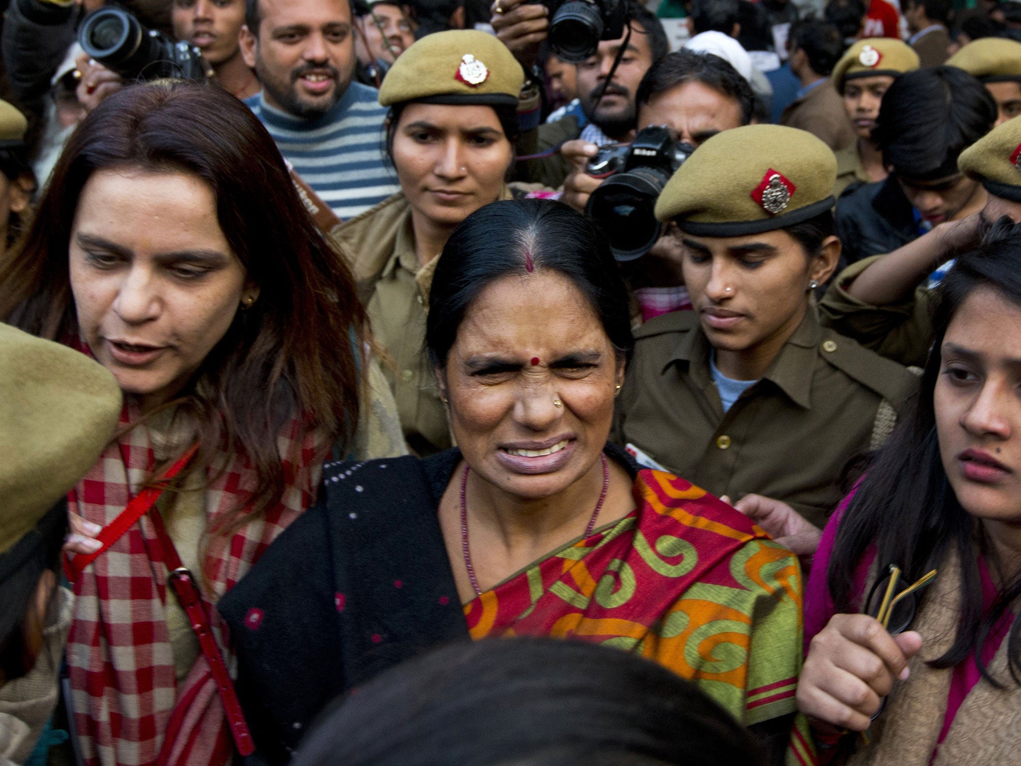 The mother of the victim of the fatal 2012 gang rape that shook India, arrives to lend her support at a protest in New Delhi, India, Monday, Dec. 21, 2015.