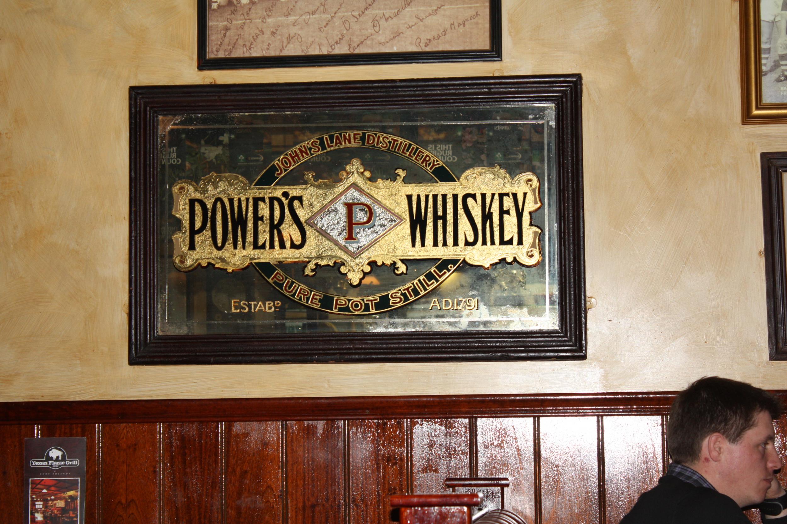 Power's Whiskey mirror in a pub