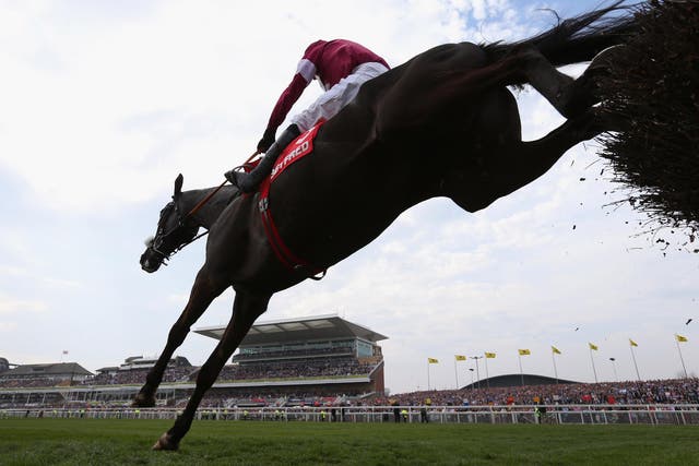 Don Cossack ridden by Tony McCoy jumps the last fence on their way to winning the Betfred Melling Steeple Chase at Aintree Racecourse on April 10, 2015 in Liverpool, England