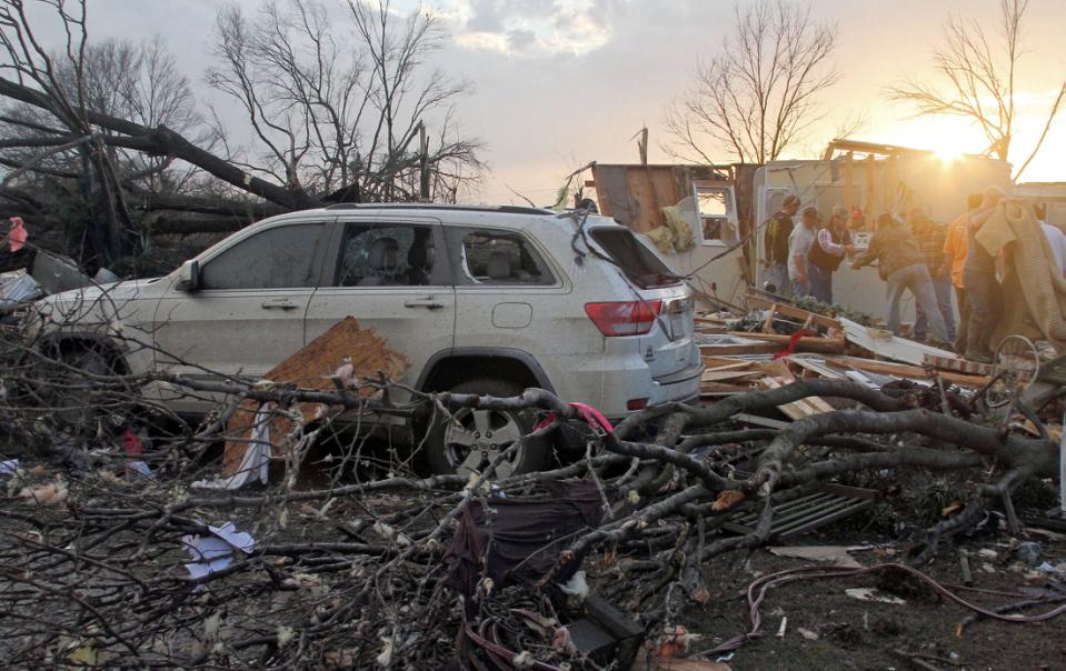 Neighbors salvage items from a home near Clarksdale, Mississippi