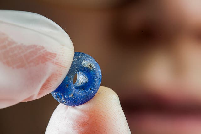 A delicate blue glass bead found during the dig