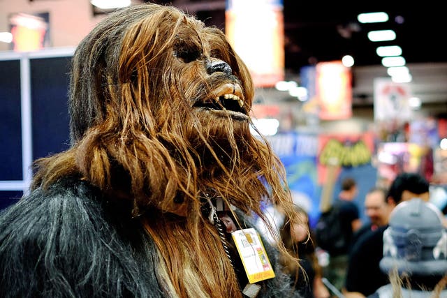 Christopher Petrone, of San Diego, CA, towering over attendees in his handmade, to-scale Chewbacca costume, during the 45th annual San Diego Comic-Con