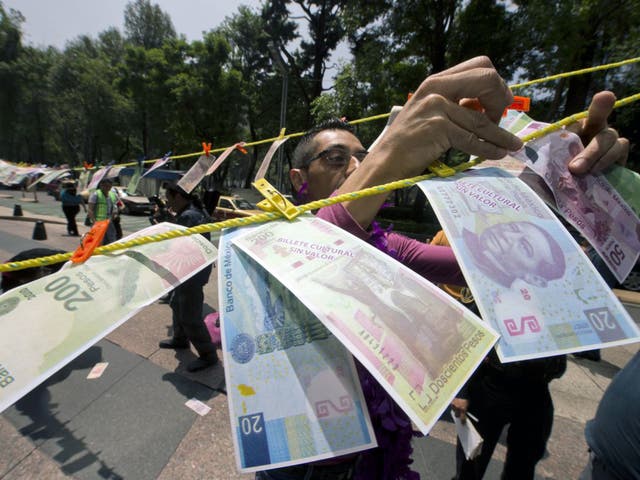 A protest over drug money in Mexico City – the US government estimates that over £19bn in laundered money crosses the border with Mexico each year