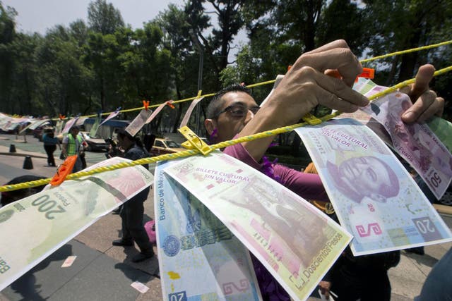 A protest over drug money in Mexico City – the US government estimates that over £19bn in laundered money crosses the border with Mexico each year