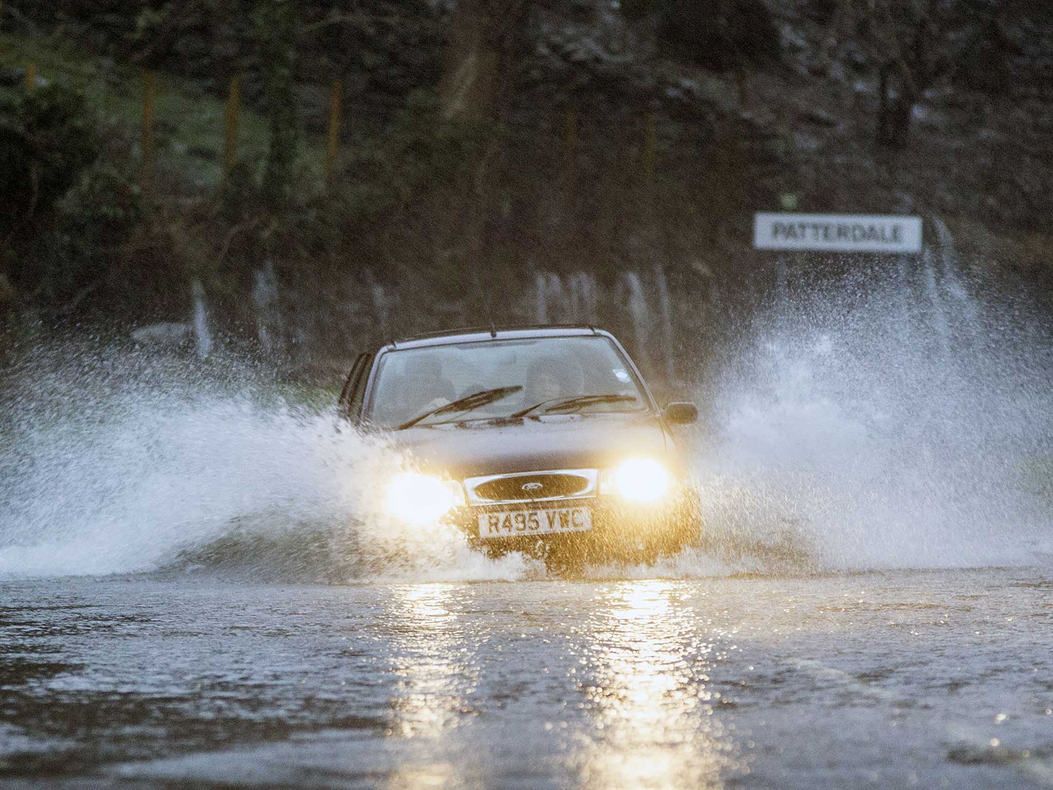 A car battles through flooded roads in Patterdale