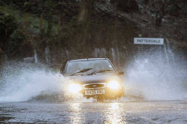 A car battles through flooded roads in Patterdale