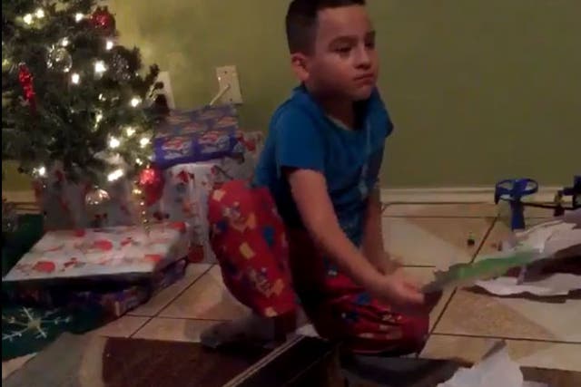 The young boy after realising he got the wrong present