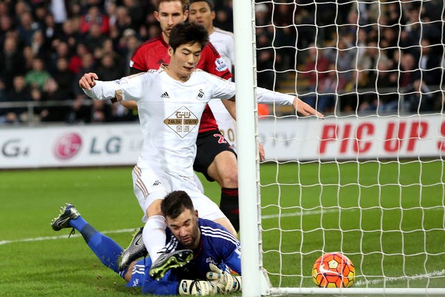 Ki Sung-yeung forces the ball over the line to give Swansea the lead against West Brom