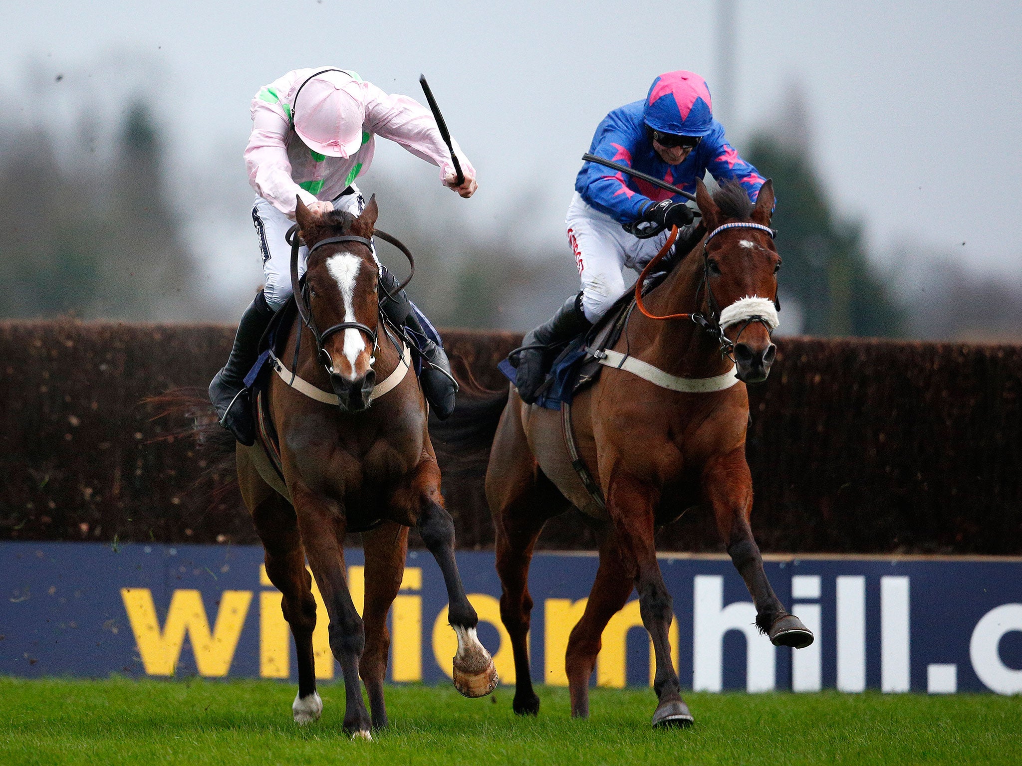 Cue Card (right) battles with Vautour (left) in the home stretch of the King George VI Chase