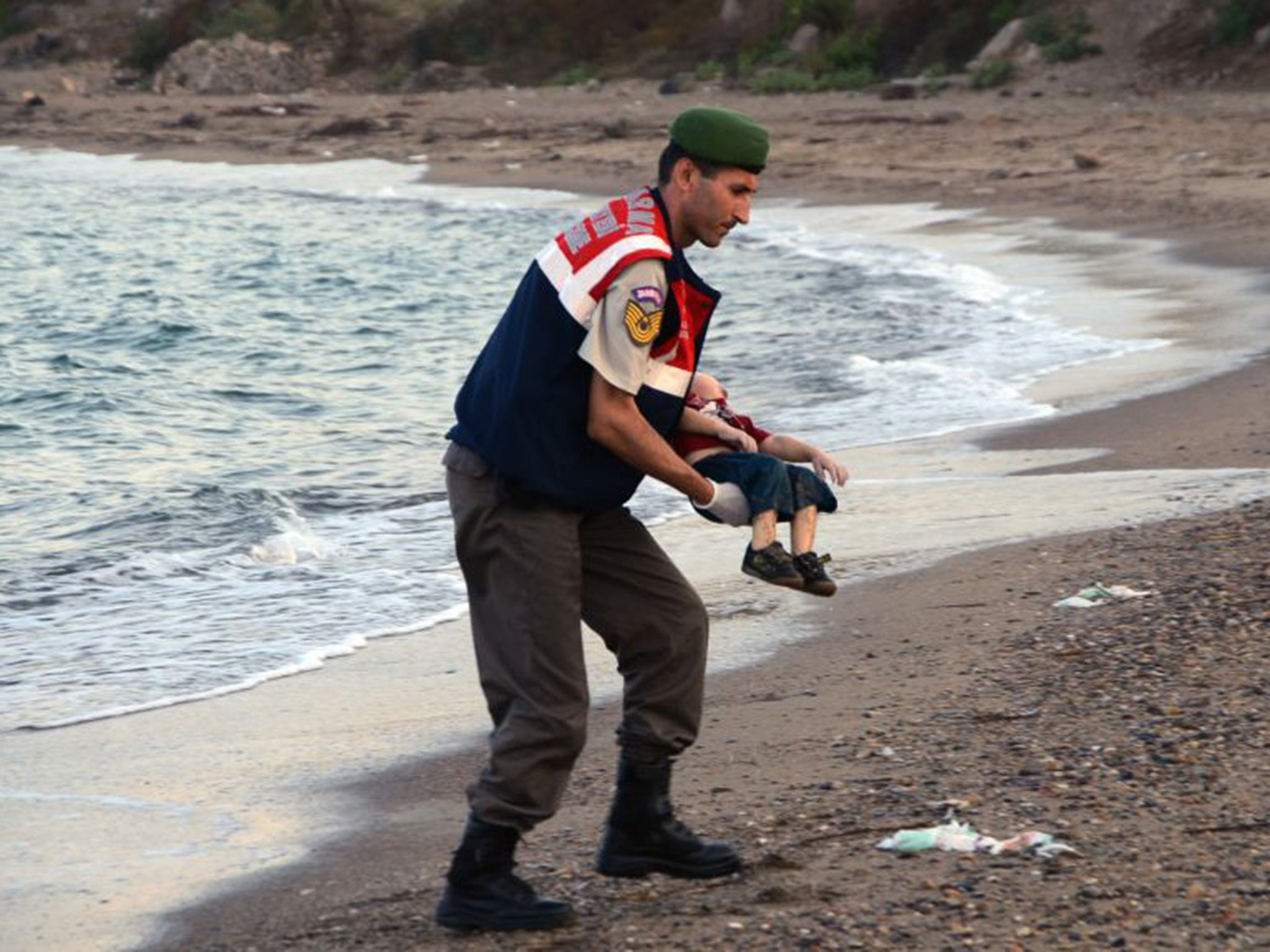 Image of 2015: Aylan Kurdi’s body is taken from a beach in Turkey last September