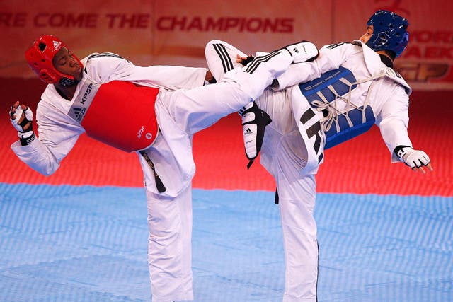 Lutalo Massop Muhammad (red) of Great Britain and Mehdi Khodabakhshi (blue) of Iran compete in the World Taekwondo Grand Prix