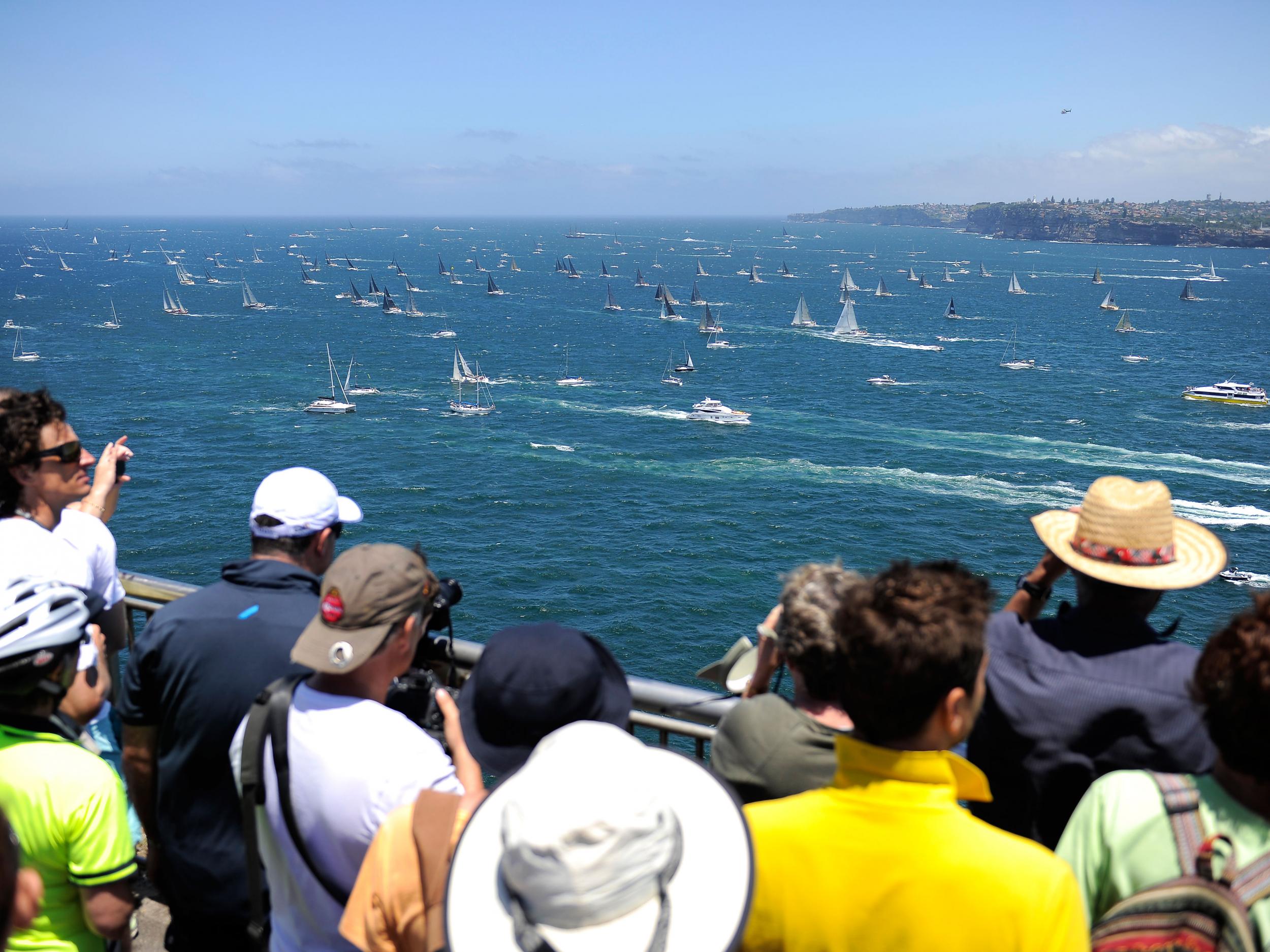 Spectators look on as the fleet leaves Sydney Heads during the 2014 Sydney To Hobart