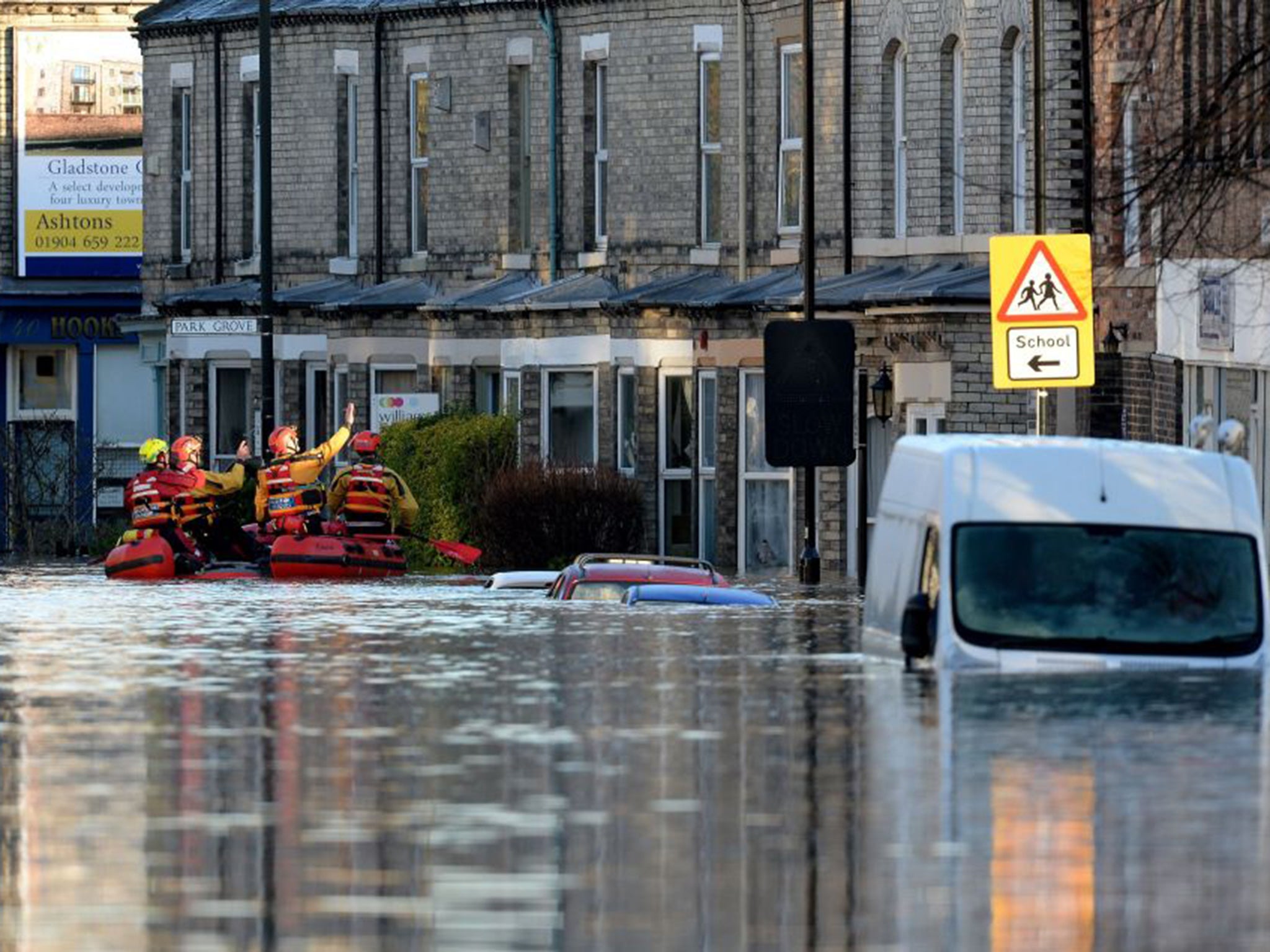 Members of a Mountain Rescue team paddle along Huntington Road in York, after the River Foss and Ouse burst their banks.