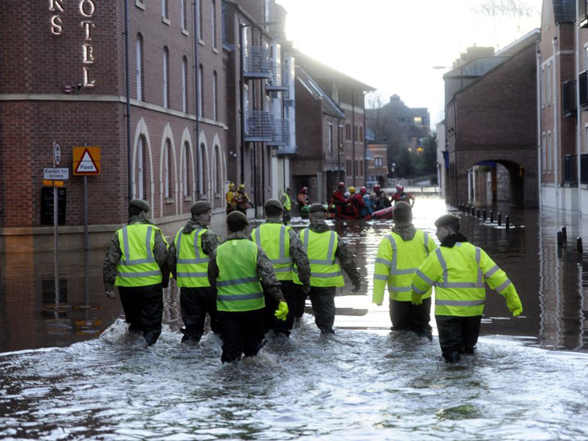 Members of the Army and rescue teams help evacuate people from flooded properties after they became trapped by rising floodwater when the River Ouse bursts its banks in York city centre.
