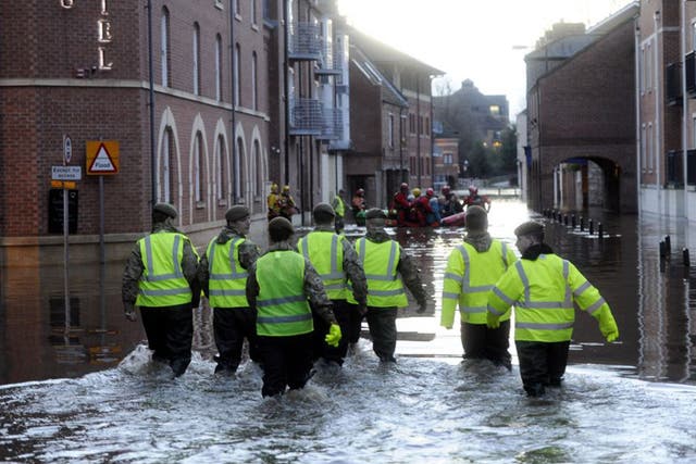 Members of the Army and rescue teams help evacuate people from flooded properties after they became trapped by rising floodwater when the River Ouse bursts its banks in York city centre.