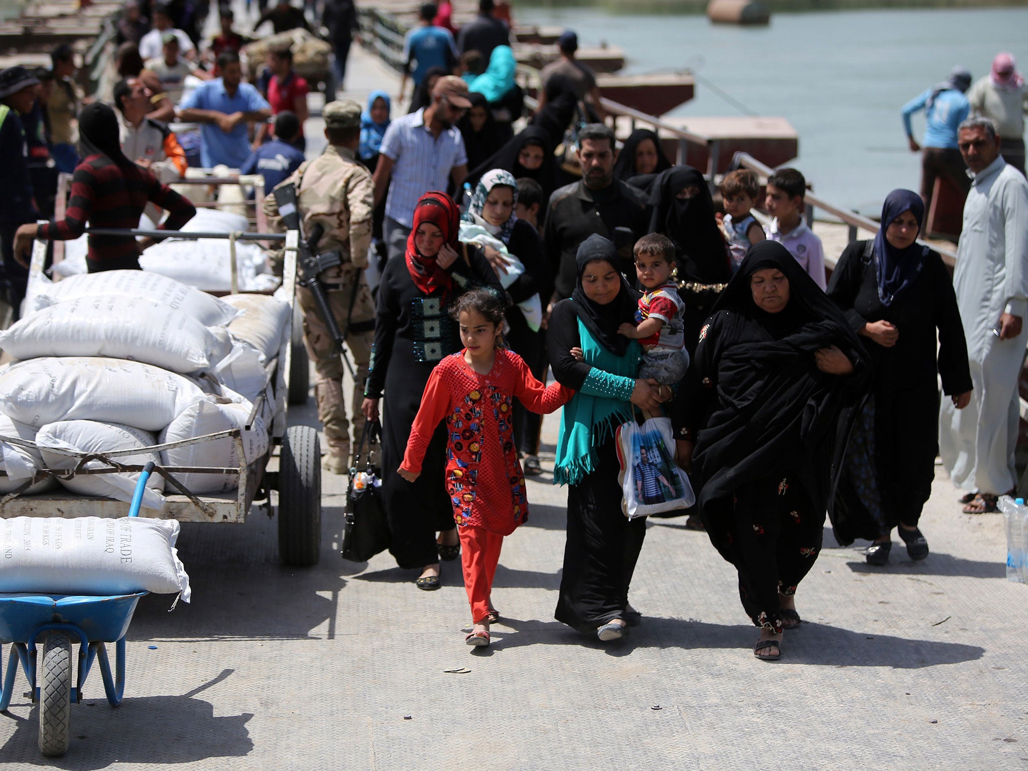 Sunni Iraqis fleeing violence in Ramadi arriving in Baghdad; more than 90,000 people have fled fighting between pro-government forces and Isis in the Ramadi area