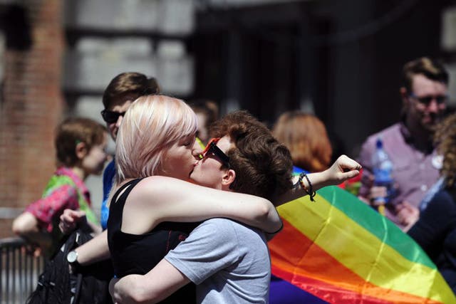 A couple kiss after early results suggest an overwhelming majority in favour of the referendum on same-sex marriage, in Dublin, Ireland, 23 May 2015