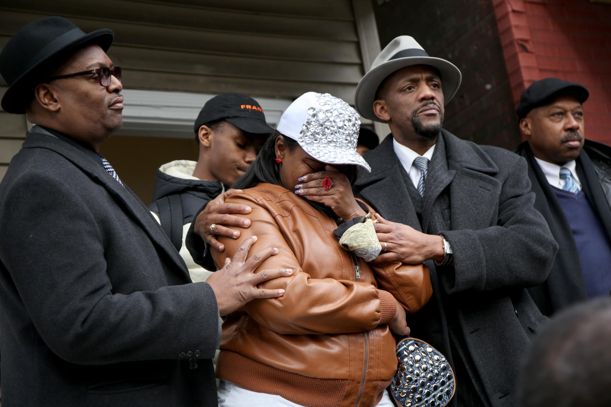 LaTarsha Jones, center, the daughter of Bettie Jones, is comforted by family during a press conference on Sunday.