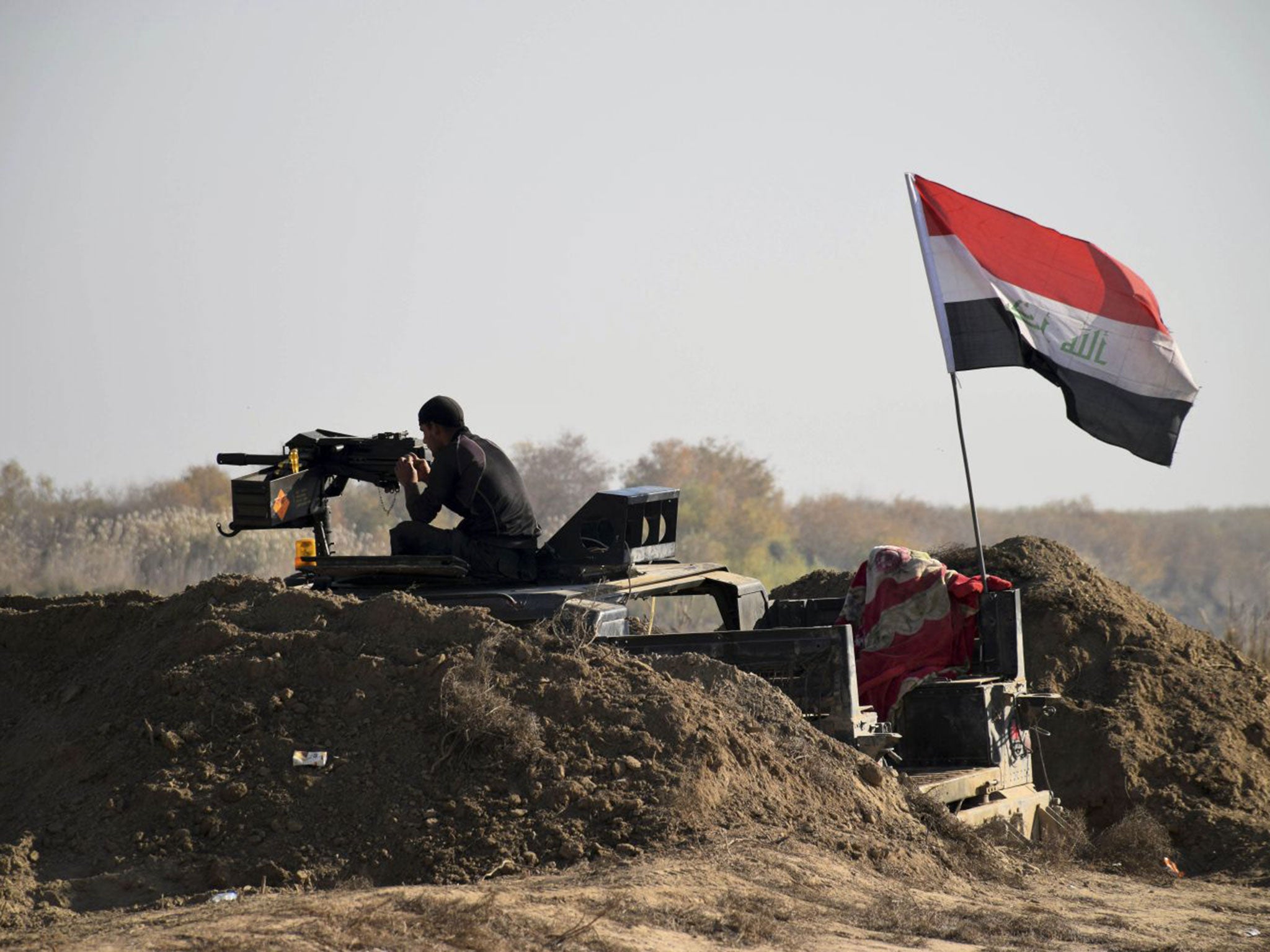 Iraqi Security forces with national flag enter downtown Ramadi, 55 miles west of Baghdad, Iraq