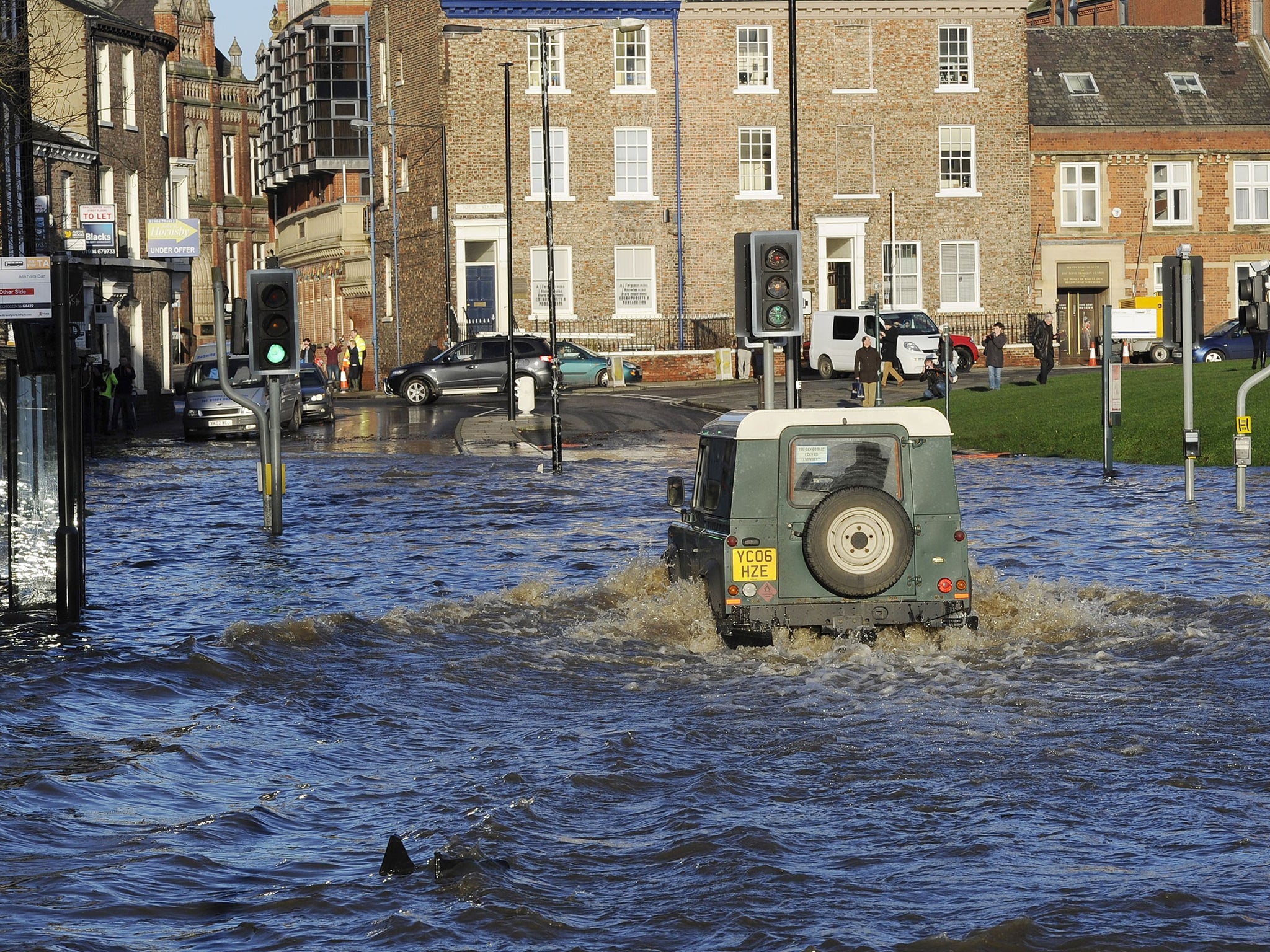 A Land Rover is driven through floodwater in York city centre, after the River Ouse and the River Foss burst their banks.