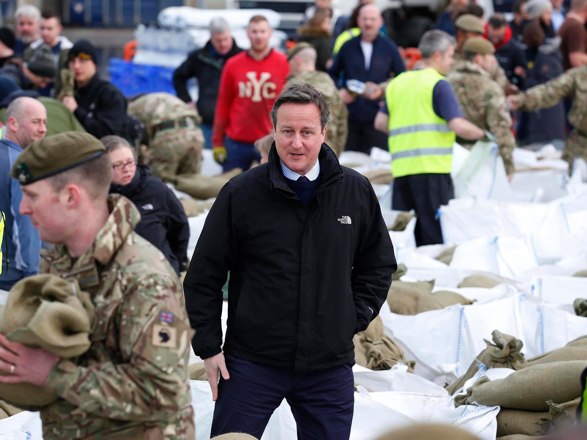 David Cameron visits a local council depot as local volunteers and the British Army fill sandbags to stem flood water in York city centre