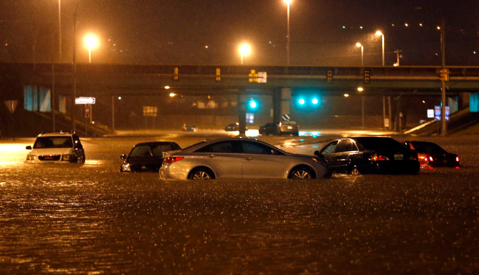 Cars sit submerged in flood waters on Tallapoosa Street, Friday, Dec. 25, 2015, in Birmingham, Alabama.