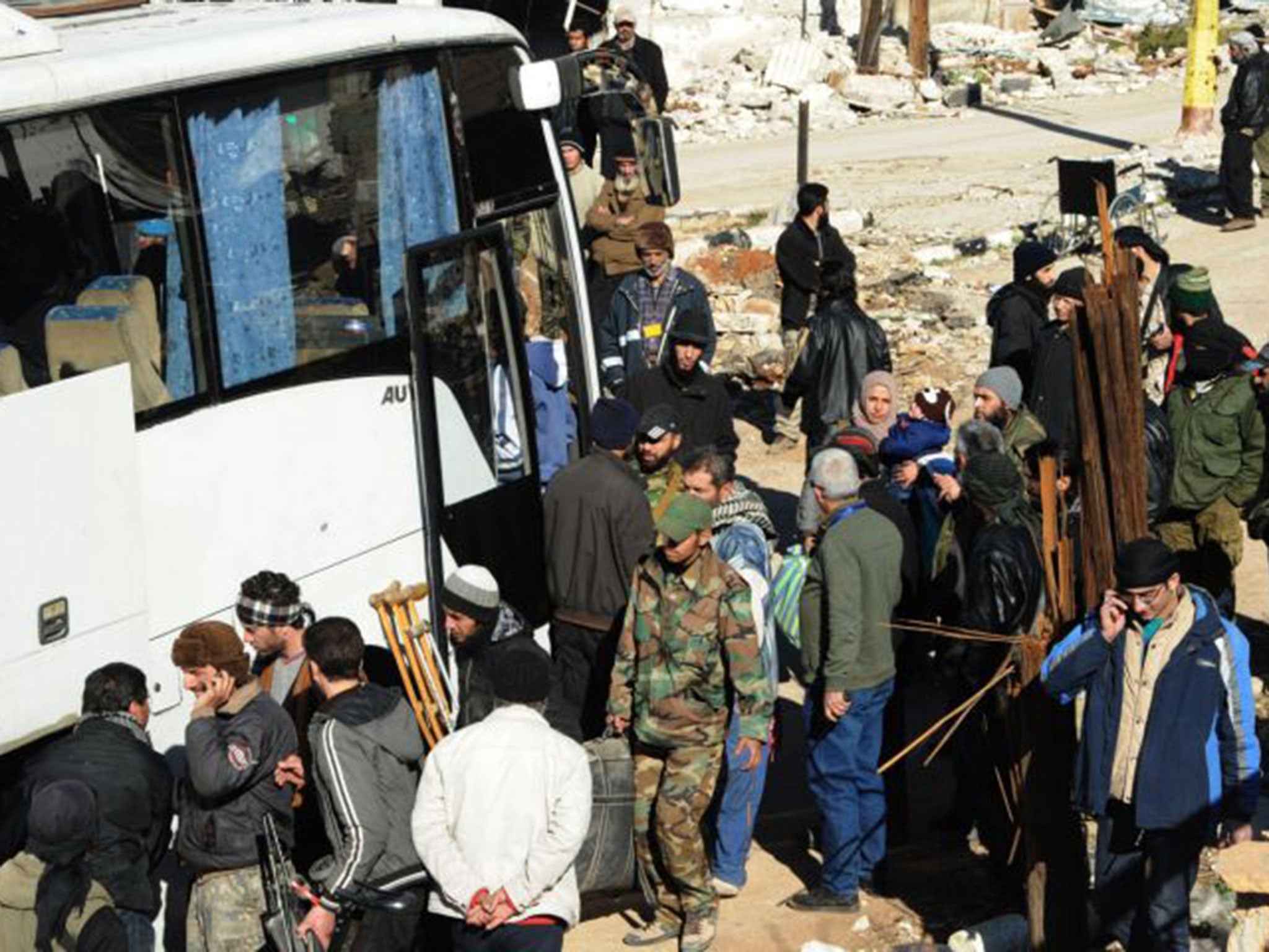Syrian opposition fighters and their families prepare to evacuate the town of Zabadani