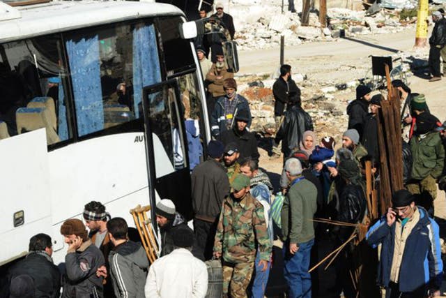 Syrian opposition fighters and their families prepare to evacuate the town of Zabadani