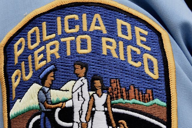 A police officer's shoulder patch is seen in the old town district in San Juan, Puerto Rico. AFP PHOTO / PAUL J. RICHARDS