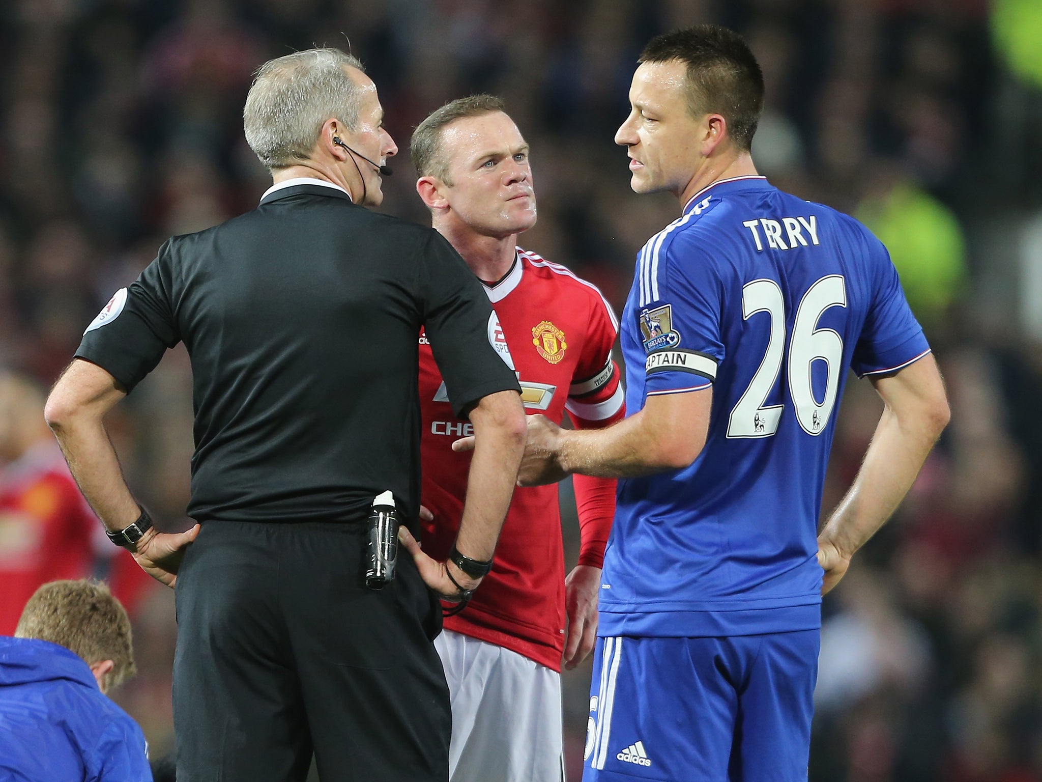 The captains, Wayne Rooney and John Terry with referee Martin Atkinson