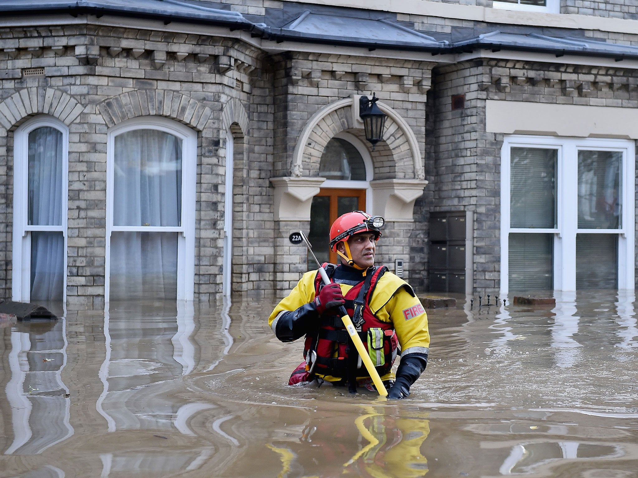 Rescue teams wade through flood waters that have inundated homes in the Huntington Road area of York after the River Foss burst its banks, on 28 December, 2015