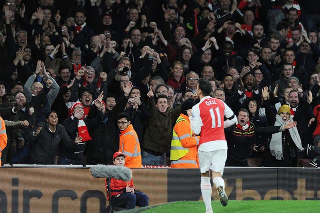 Mesut Ozil celebrates his goal in front of the Arsenal faithful
