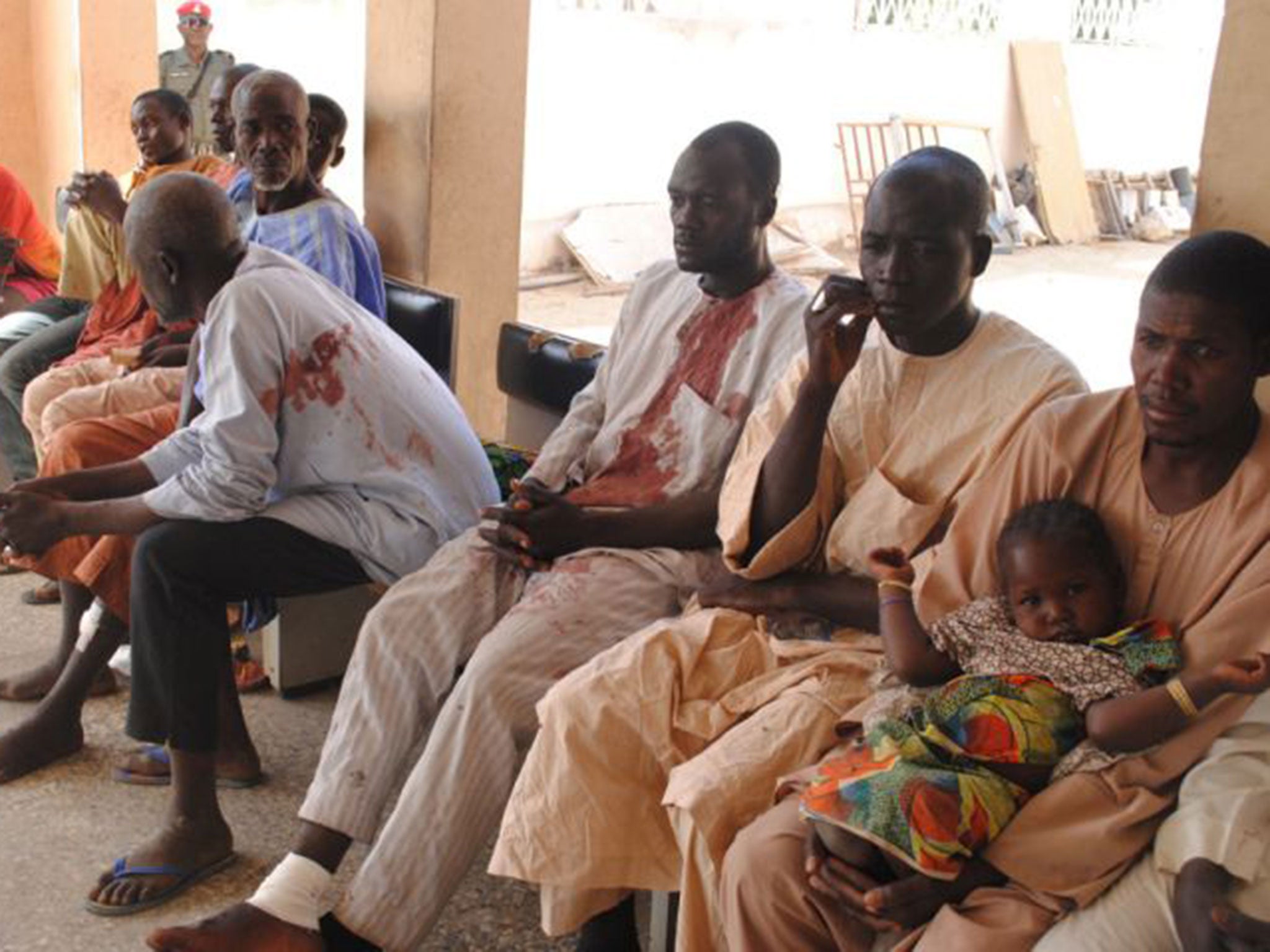 Victims of the Boko Haram attack wait for treatment at a hospital in Maiduguri