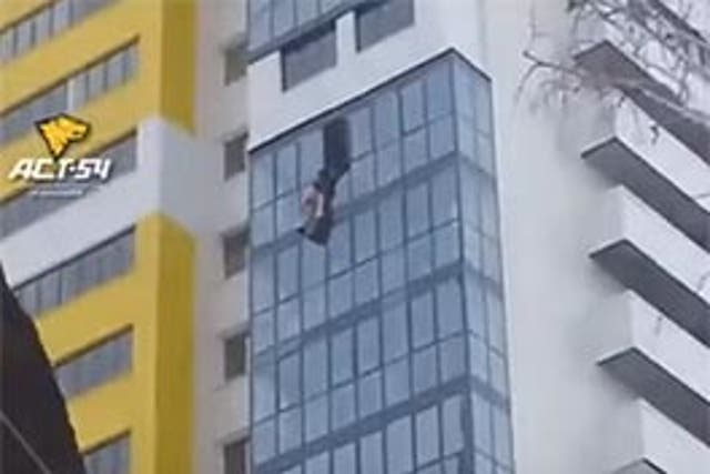 The man was dangling from a 15th floor window