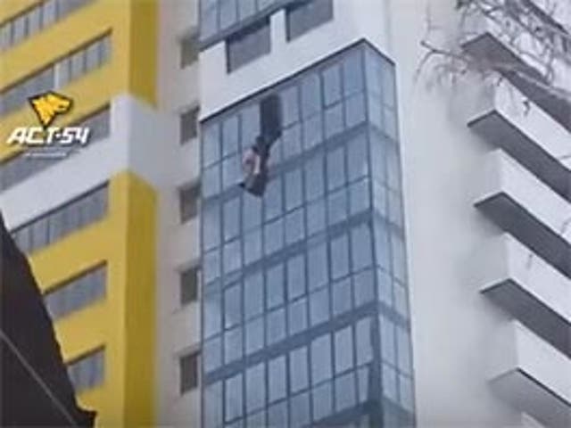 The man was dangling from a 15th floor window