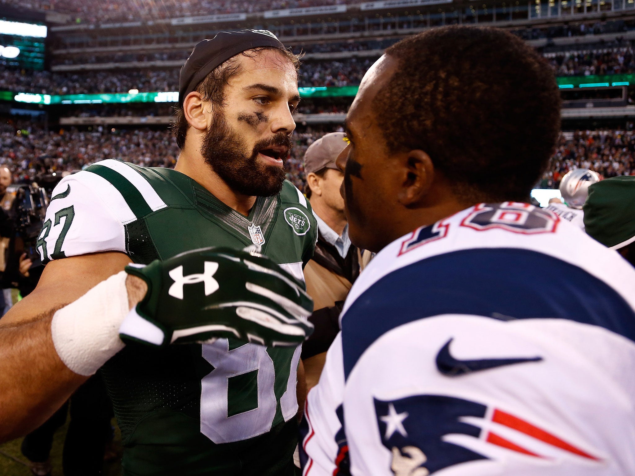 Eric Decker of the New York Jets speaks with Matthew Slater of the New England Patriots