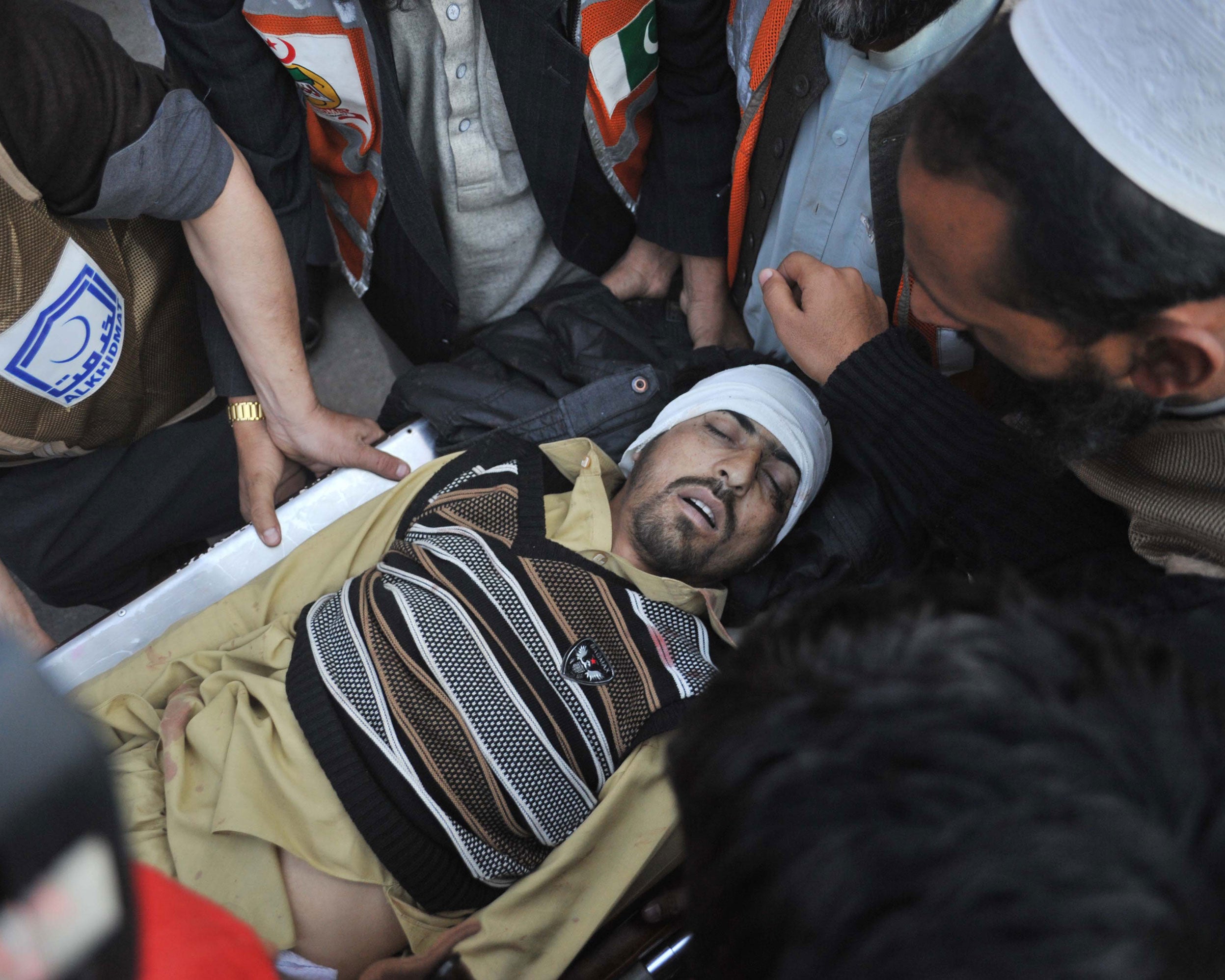 Pakistani paramedics transport a bomb blast victim to a hospital in Peshawar