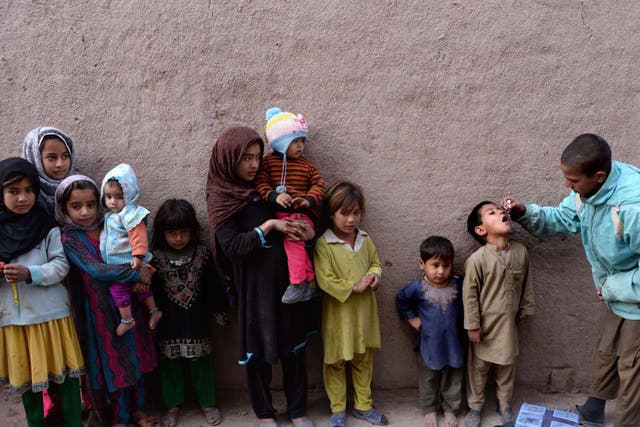 Children queue for the polio vaccine in Jalalabad earlier this month. Isis has been intimidating vaccination workers, saying the scheme is a Western conspiracy