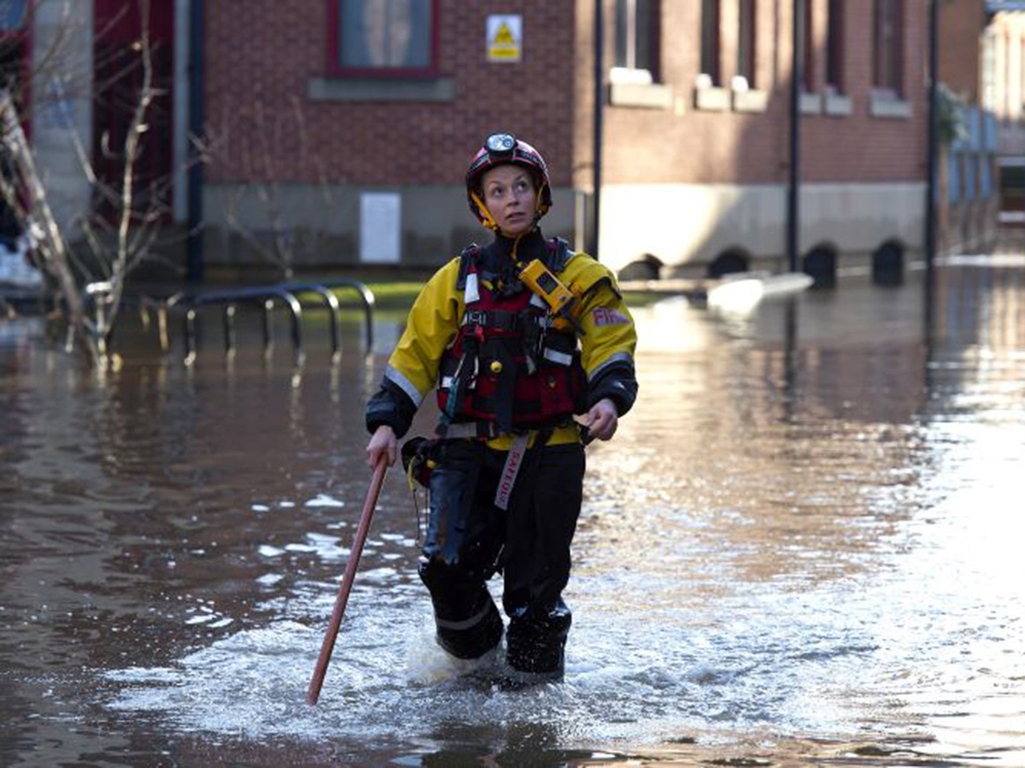 Rescue crews use poles to check the depth of the flood water in Skeldergate on December 29