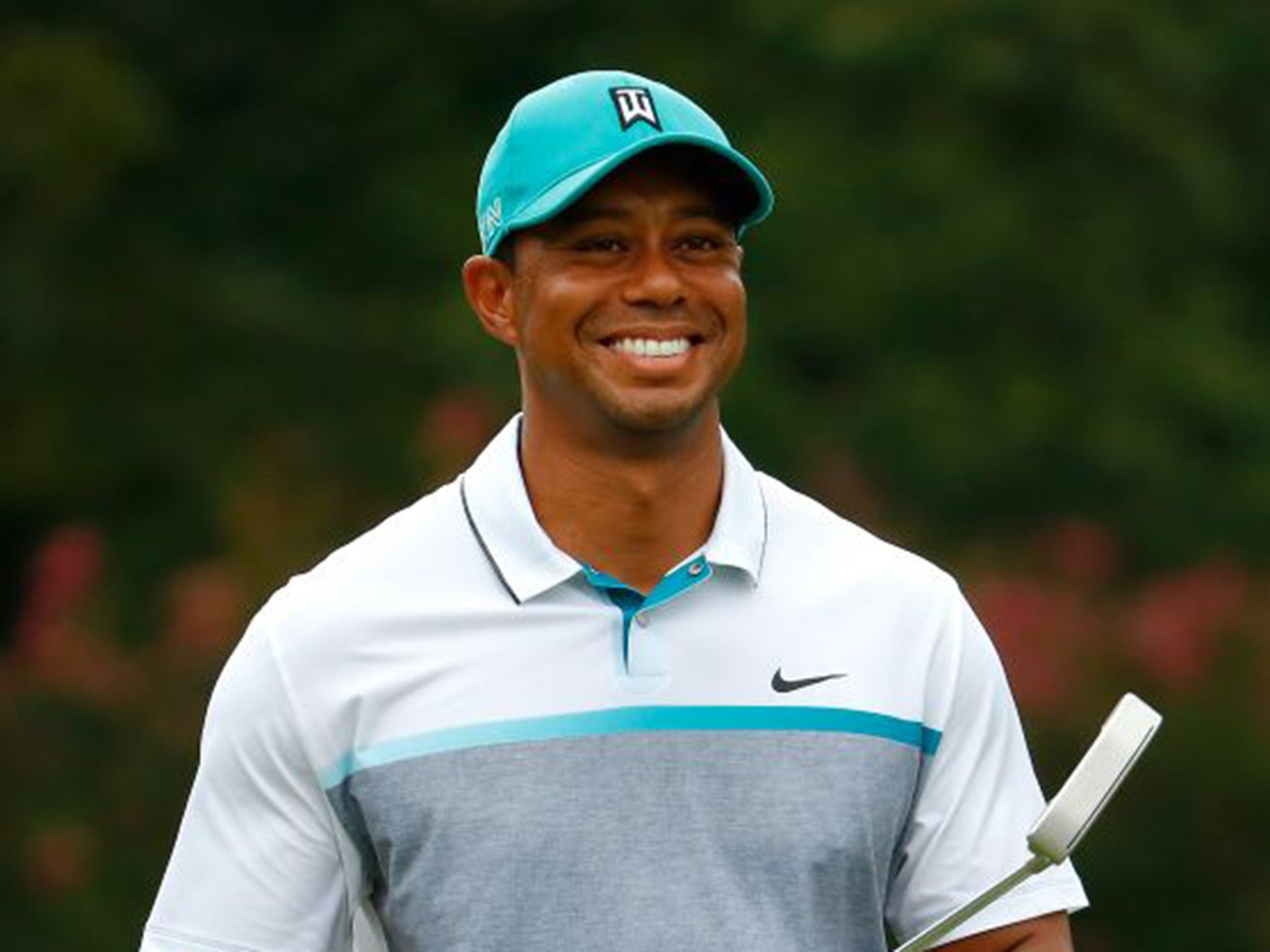Tiger Woods is all smiles after sinking a birdie at the Wyndham Championship back in August before undergoing a third back operation in 18 months